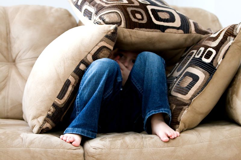 Datei:Kleiner Junge Kind Angst Verstecken Sofa Furcht.jpg